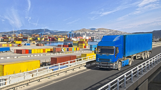 Truck on a bridge near a port