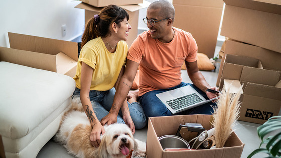 Man and woman at home among moving boxes