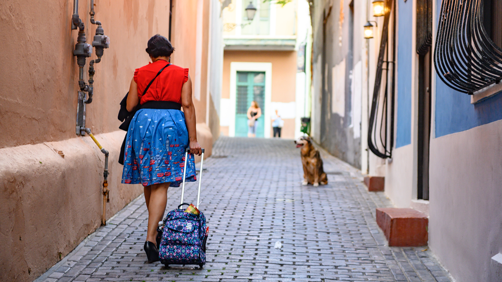 Woman walks down street in Puerto Rico 