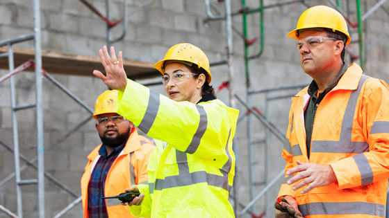 Construction workers discuss matters on the job.