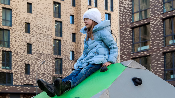 Child on playground in residential neighborhood. 