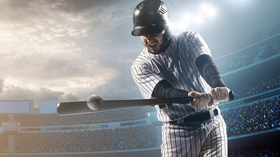 A batter swings his bat at a baseball.