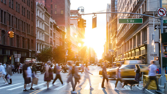 People walking across a city street