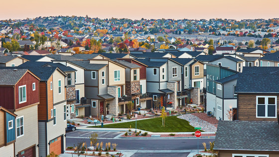 Modern townhomes line a suburban street.