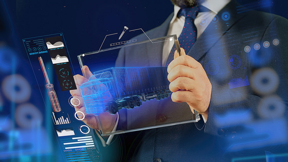 A person holds a tablet displaying data and graphics.