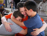 Children hug a volunteer at the Children of Inmates program in Florida
