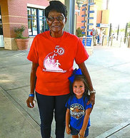 Foster Grandparent Helen Brown poses with Melissa, a student at Midland College’s Children Center, before they attend a Midland Rockhounds game.