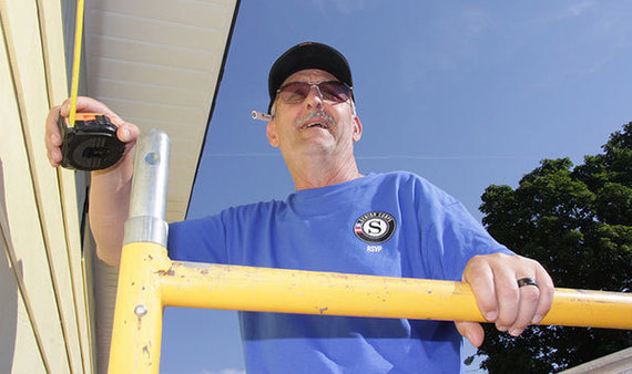 A Senior Corps RSVP volunteer serves on a housing project.