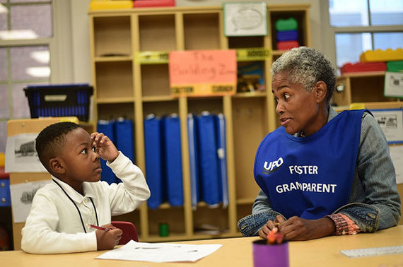 Foster Grandparent Cassandra Reid helps second-grader Eric Hill with his classwork at a Washington, D.C., school. (Washington Post photo)
