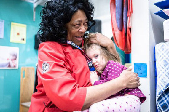 Senior Corps Foster Grandparent Thomasina Brownlee, 63, hugs a child at the Asheville YWCA's Early Learning Program. (Matt Burkhartt/Citizen Times)