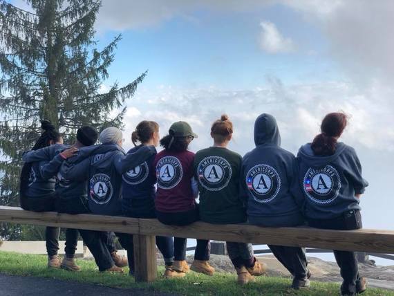 AmeriCorps members proudly show of the program logo on the "Day of the A."