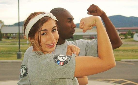 AmeriCorps members posing as Rosie the Riveter and man