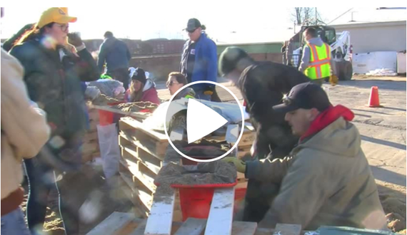 Video of volunteers filling sandbags