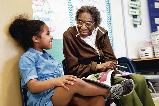 Senior Corps Foster Grandparent Elizabeth McDaniel, who reads with first-grader Nilah Conaway, says she enjoys being around the students.