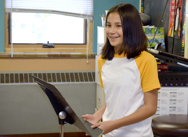 Tiffany Garber, a sixth-grader at St. Paul Lutheran School, introduces the next speaker during the Speak Up presentation led by RSVP. 