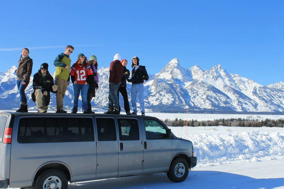 Members standing on a van in the snow