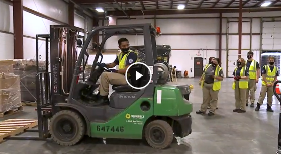 FEMA Corps member using forklift while team watches