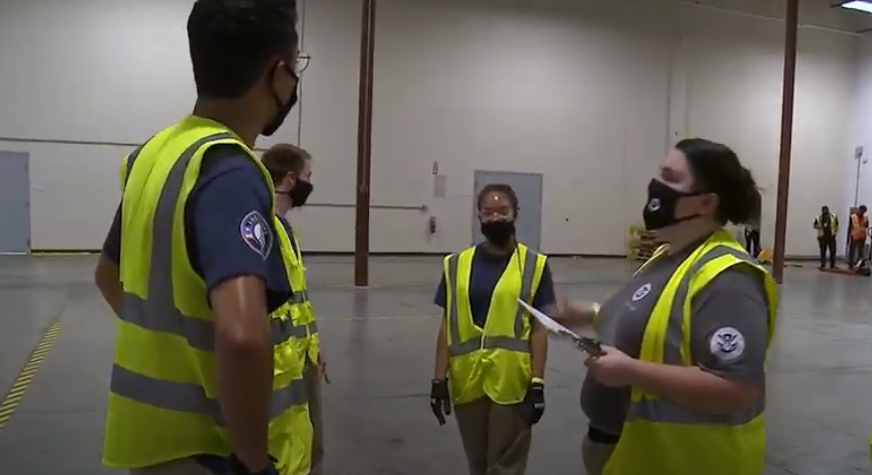 FEMA Corps team leader instructing team members in a warehouse