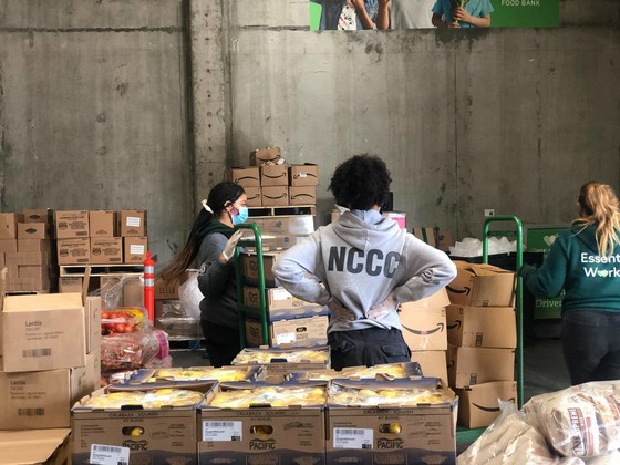 Member working in warehouse with volunteers
