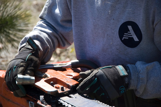 Close up shot of member wearing gloves working with tools