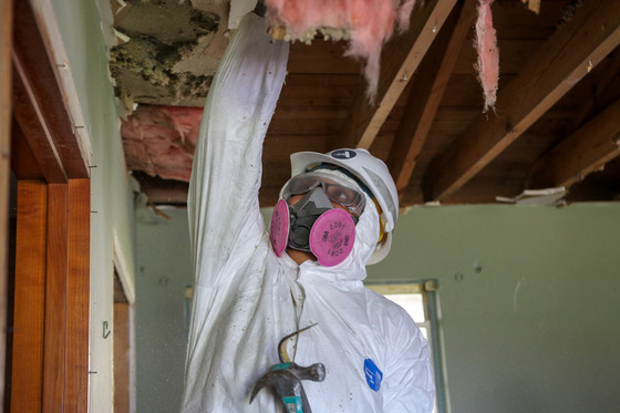 Member working inside a home on the ceiling