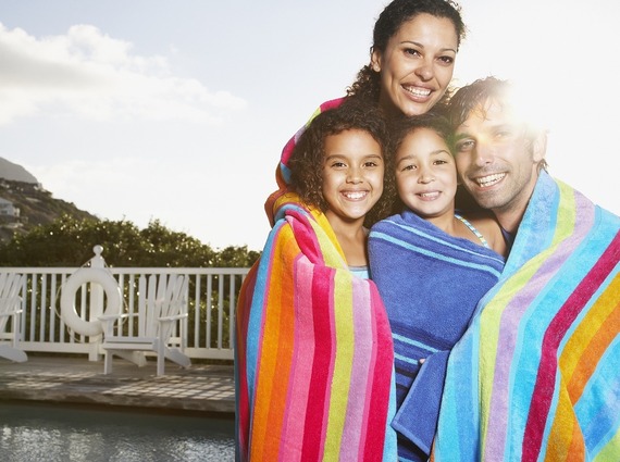 happy adults and children at a swimming pool