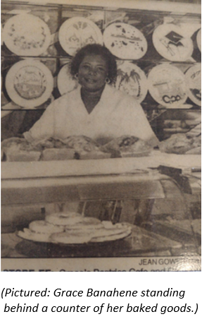 A picture of Grace Banahene standing behind a counter of her baked goods