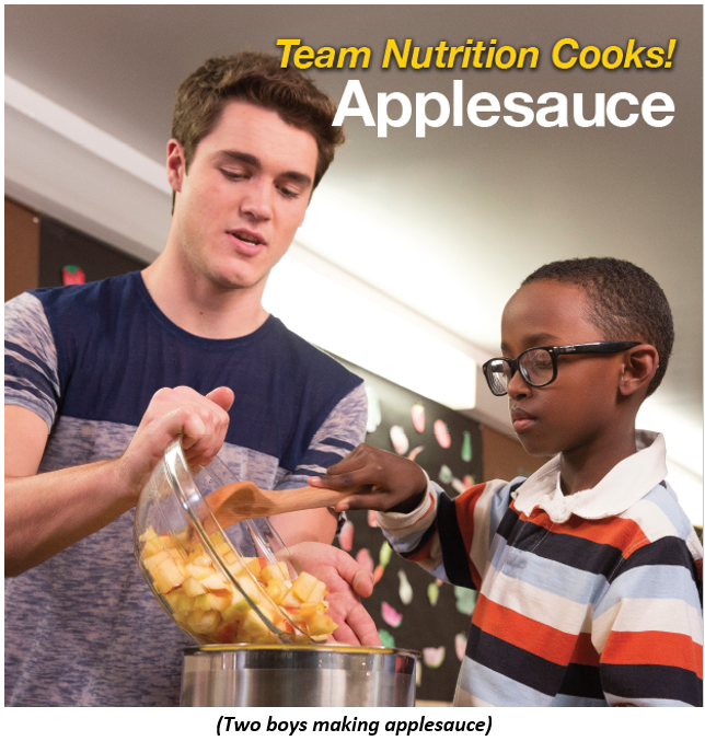Two boys making applesauce