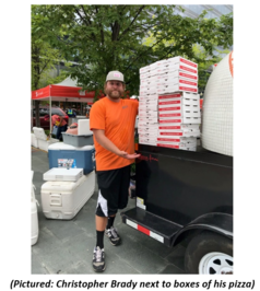 Christopher Brady next to his boxes of pizza