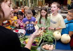 Lady teaching kids about health of food