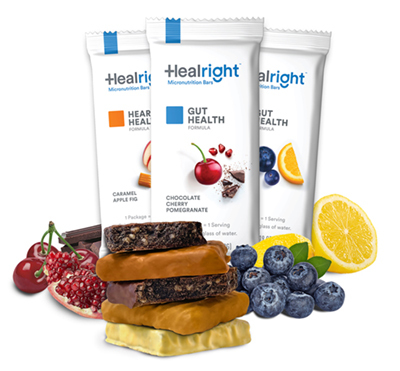 Three packaged Heal Right health bars surrounded by fruit