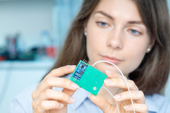 Researcher holds an organ-on-a-chip.