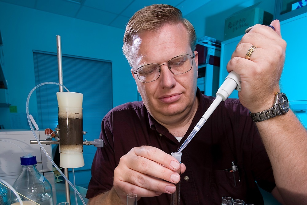 ARS soil scientist Clinton Williams draws samples of reclaimed water used for irrigation. (Photo by Stephen Ausmus)