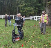 An Earth Team volunteer operates a ground penetrating radar unit at a historical site in Cass County.