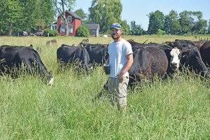 Eaton County farmer Evan Boehmer with one of his angus herds.