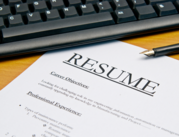 resume and computer keyboard on a desk