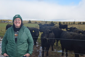 Waishkey Bay Farm Manager Kat Jaques stands in front of the farm's beef cattle herd.