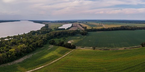 Overheard view of farmland next to a river