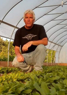 Gary Shepherd, owner of Bonz Beach Farms in Presque Isle County, in one of his farm's two high tunnels.