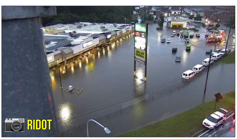 Aerial photo of a strip mall parking lot in Rhode Island, with parked cars sitting in flood water