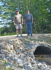 Brothers John and Robert Simmons stand on the fish passage constructed on their property in Kent County.