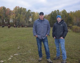 Hillman cattle farmer Todd Robinson and NRCS District Conservationist Bryan Zabel with grazing cattle.