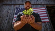 Man holding plant in his hand