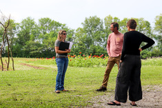 FSA staff meeting with couple in their farm yard