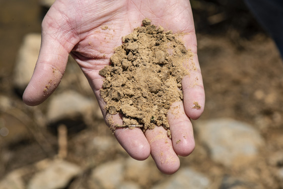 hand holding light brown soil