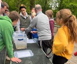 Students get a lesson in aquatic ecology along the Red Cedar River at MSU during the 2024 Michigan Envirothon State Competition..