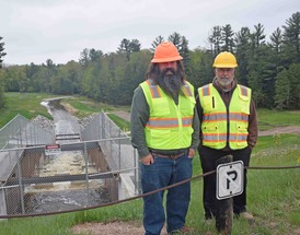 NRCS Civil Engineer Dan Vasher and Moffatt Township Supervisor Ray Daniels stand above the recently completed Forest Lake spillway.