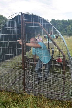 Christopher and Ryan Thatcher move one of their farms chicken tractors. 
