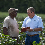 Farmer and USDA employee review documentation