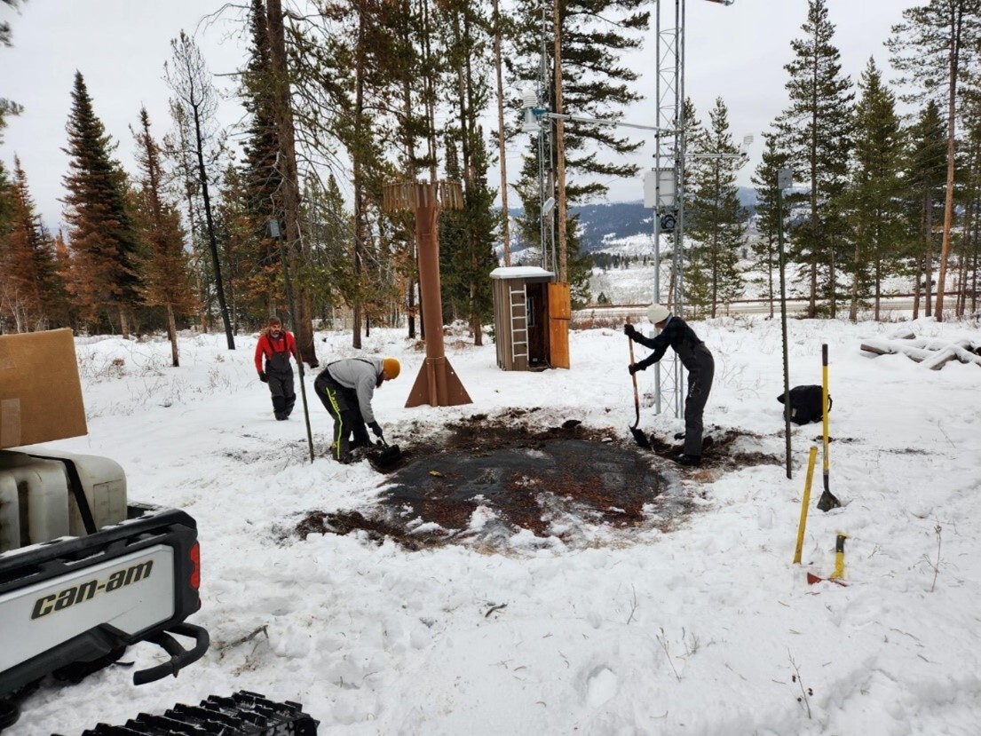A three-person crew replaces the snow pillow at the Salt River Summit SNOTEL site.